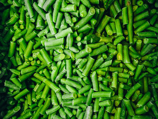 A lot of frozen string beans shot from above. Texture, background.
