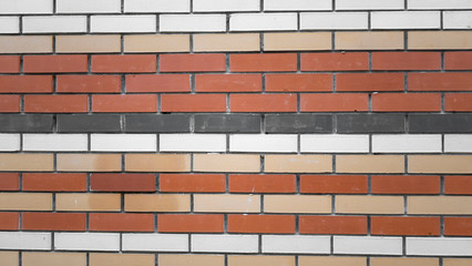 Brick wall, texture. Modern brickwork of white, black and red bricks fixed together with mortar. Facing bricks of modern residential buildings and structures. Template, design. 