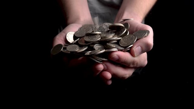 Dropping charity coins to a open donation hand