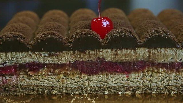 closeup panorama right at half of modern shaped chocolate cake with jelly interlayer