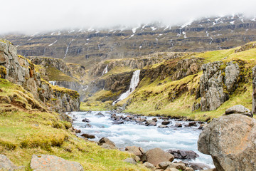 Waterfall in winter, Reyoarfjorour fjord, Iceland.