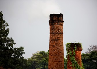 One chimney coming out of smoke and another deactivated in the brick industry
