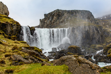 Waterfall in winter, Reyoarfjorour fjord, Iceland.