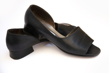 black female shoes on a white background. Flat lay, top view of fashionable beauty female background.