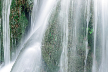 Fototapeta na wymiar Silky effect waterfalls inside the village of Torbera, Burgos, Castile and Leon, Spain.