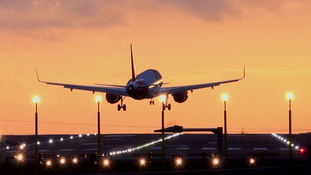 Passenger Plane Landing In The Evening Light Manchester Airport UK 4K