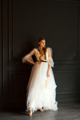 Fototapeta na wymiar portrait of a beautiful young woman with makeup in a wedding dress