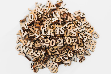 Stack of macro wooden letterpress letters with the text economic crisis in 2020.