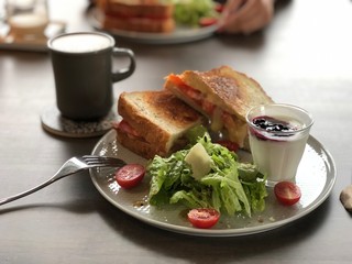 salad with sandwiches and yogurt 
