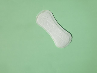 Close up view of woman's sanitary pad on color back. Top view. Copy space.