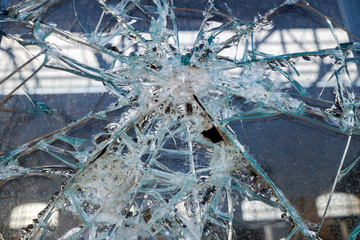 Vandals shatter glass of a window with stones.