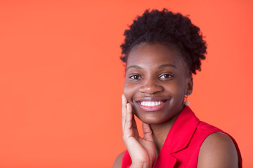 portrait of a beautiful young african woman on red background