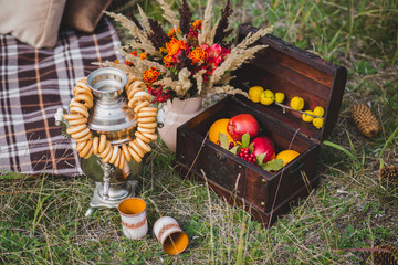Apples in a box on the grass and bouquet