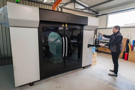 Worker Printmaker Technician Works On Large Modern 3d Printer Machine