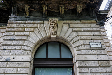 Fototapeta na wymiar A sculptured bearded man's head adorns a keystone above a window arch. The bearded head of a mature male was often used to symbolise concepts such as solidity, constancy, permanence.