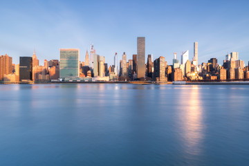 View  on Midtown Manhattan From East River during golden hour with long exposure
