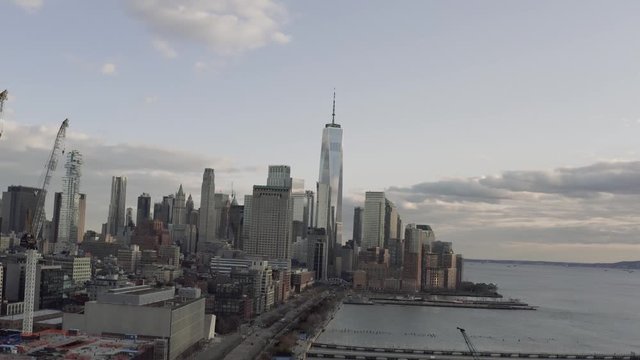 Aerial dolly in shot of New York downtown over Hudson river parkway during pandemic
