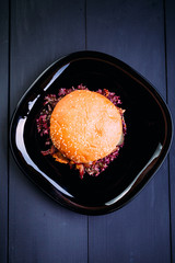 Fresh burger over wooden table and dark background. Top view