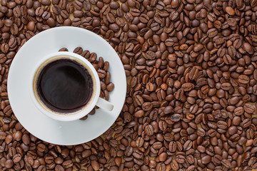 Cup of coffee on a background coffee beans