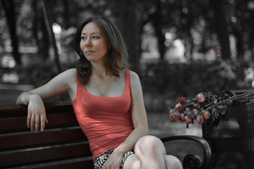 girl sitting on a bench in the park