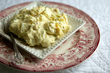 Southern style potato salad on antique plates. 