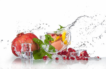 Fototapeta na wymiar summer pomegranate drink with lemon and mint with splashed water and ice
