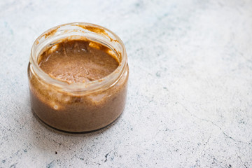 Homemade creamy peanut bar in glass jar. Copy space.