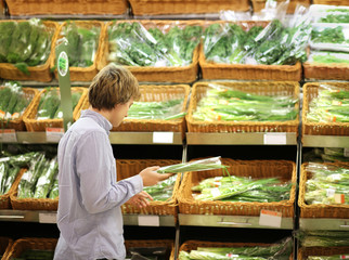 Young man buying vegetables at the market	