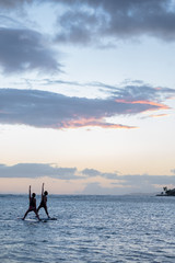 Yoga on a Stand Up Paddle Board during sunset, honolulu, HI, September 11, 2018