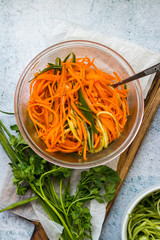 Traditional Korean spicy hot carrot salad with garlic and soy sauce. Grated raw carrot in glass bowl. Vegan healthy food.