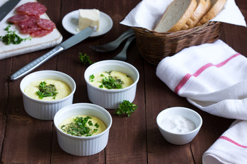 Breakfast of omelet, sausage, bread and butter on a dark background.