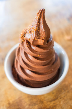 Chocolate soft serve with carmel brittle on top in a bowl