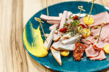 in a plate ham cheese mustard vegetables