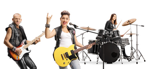 Two female and one male musician in rock band performing