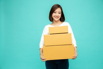 Fototapeta na wymiar Happy Asian woman holding package parcel box, Delivery courier and shipment service concept