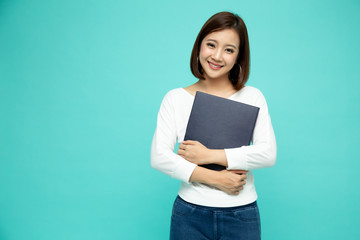 Asian businesswoman holding documents files standing over green background - Powered by Adobe