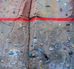 Bold red line painted on a rock, climbing equipment, limits and boundary marking.