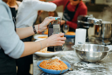 rubs parmesan into pasta