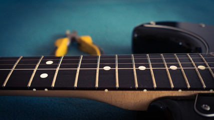 Fototapeta na wymiar changing strings to black electric guitar