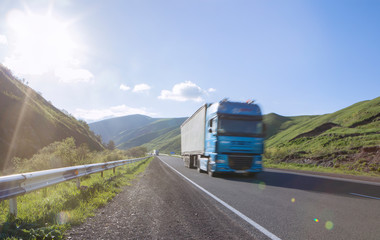 international shipping; a truck with a load goes on the highway