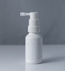 Pharmacy. Throat spray medication in white bottle isolated on white background