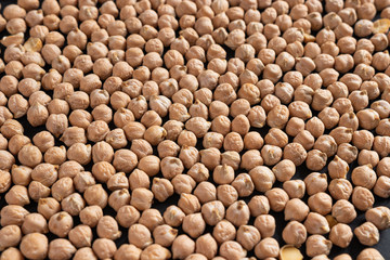 a lot of dried chickpeas for making hummus on a black background