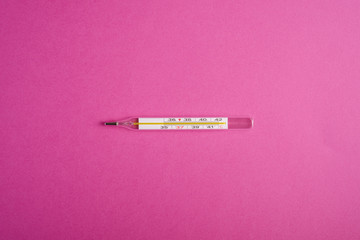 Analog thermometer on pink purple background, healthcare medical concept, antibiotics and cure, top...