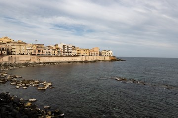 Cityscape of the Siracusa city in Sicily, Italy with a fortification on the Lungomare Ortigia street