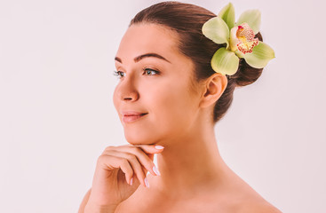 Fototapeta premium Portrait of young attractive woman beauty model with perfect face skin posing isolated on background. Beautiful girl touching smooth face and smiling. Skin treatment, beauty and wellness, peeling