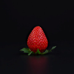 Ripe strawberry on black background