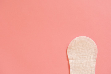 Menstrual cycle. White feminine pad on a pink background.