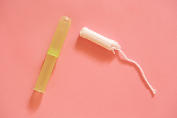 Menstrual cycle. White female tampons on a pink background.