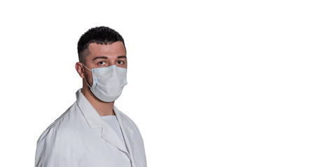 portrait of a medic male brunette man in a white coat with a mask on his face on a white background. Isolated.