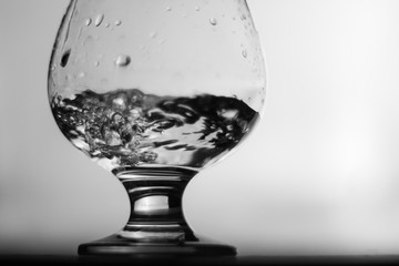 A glass of liquid. Glass. Monochrome Blurred background.